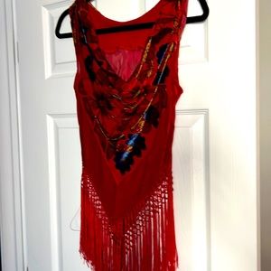 Red floral sleeveless top.  Draped front and fringed bottom